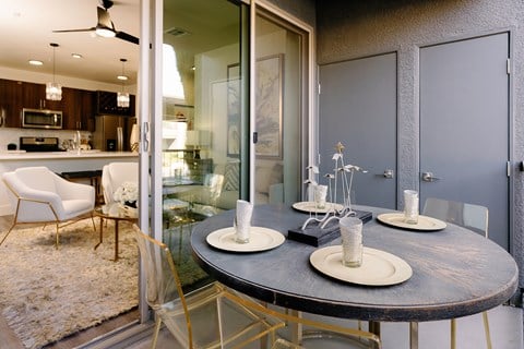 A modern dining room with a round table and chairs.